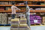 Workers unload crates of sauce at a BigBasket warehouse in Bengaluru, India, in 2018.