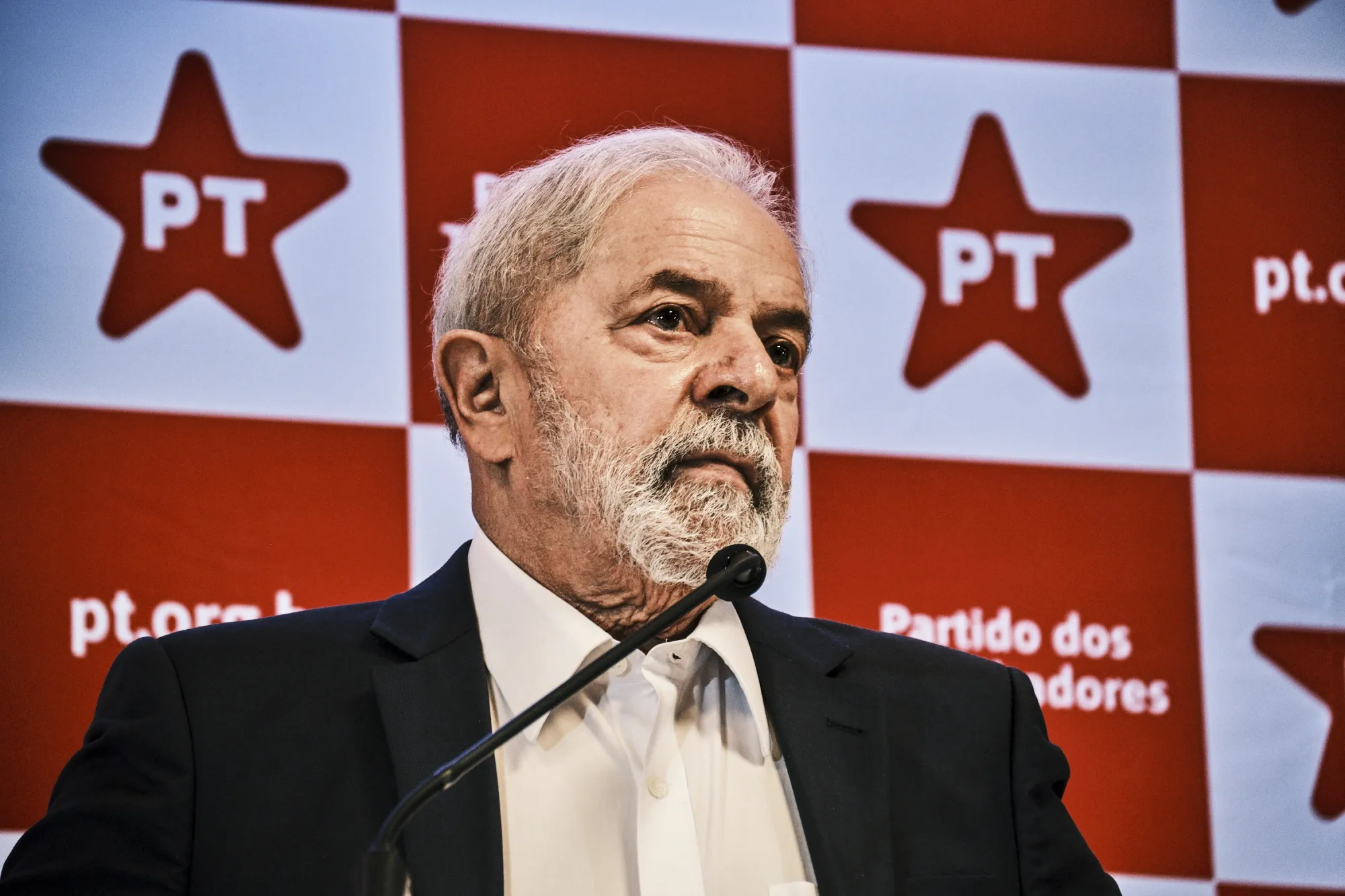 Brazil's presidential front-runner Luiz Inacio Lula da Silvas peaks during a news conference in Brasilia