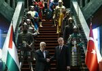 Turkey’s Recep Tayyip Erdogan, right, received Palestinian President Mahmoud Abbas, left, after passing between two columns of 16 troops, each dressed in the warrior regalia of past Turkic states, bearing period armour and toting weapons ranging from swords to lancers.
