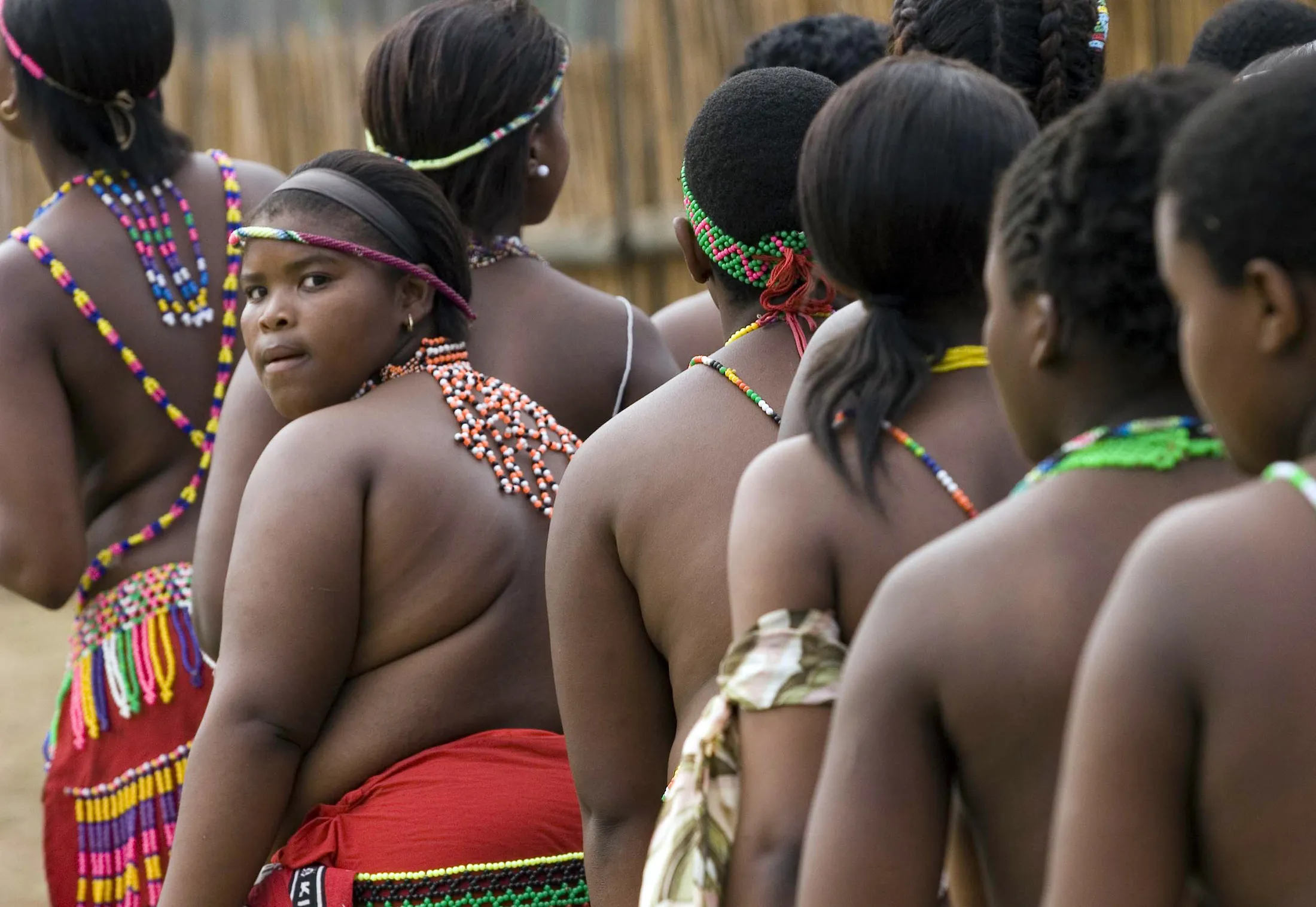 Girls wait to dance for the Zulu king at the Enyokeni Zulu royal palace in Nongoma, KwaZulu Natal, South Africa, on Sunday, Sept. 9, 2007. Thousands of virgin girls attended the annual Reed Dance at the Enyokeni palace from which the Zulu King Zwelethini may choose a bride.
