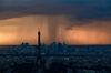 TOPSHOT - A picture taken on May 30, 2018 from the observatory deck of the Montparnasse tower in Paris shows the Eiffel Tower in Paris and La Defense business district under heavy clouds at sunset. (Photo by Philippe LOPEZ / AFP) (Photo credit should read PHILIPPE LOPEZ/AFP via Getty Images)