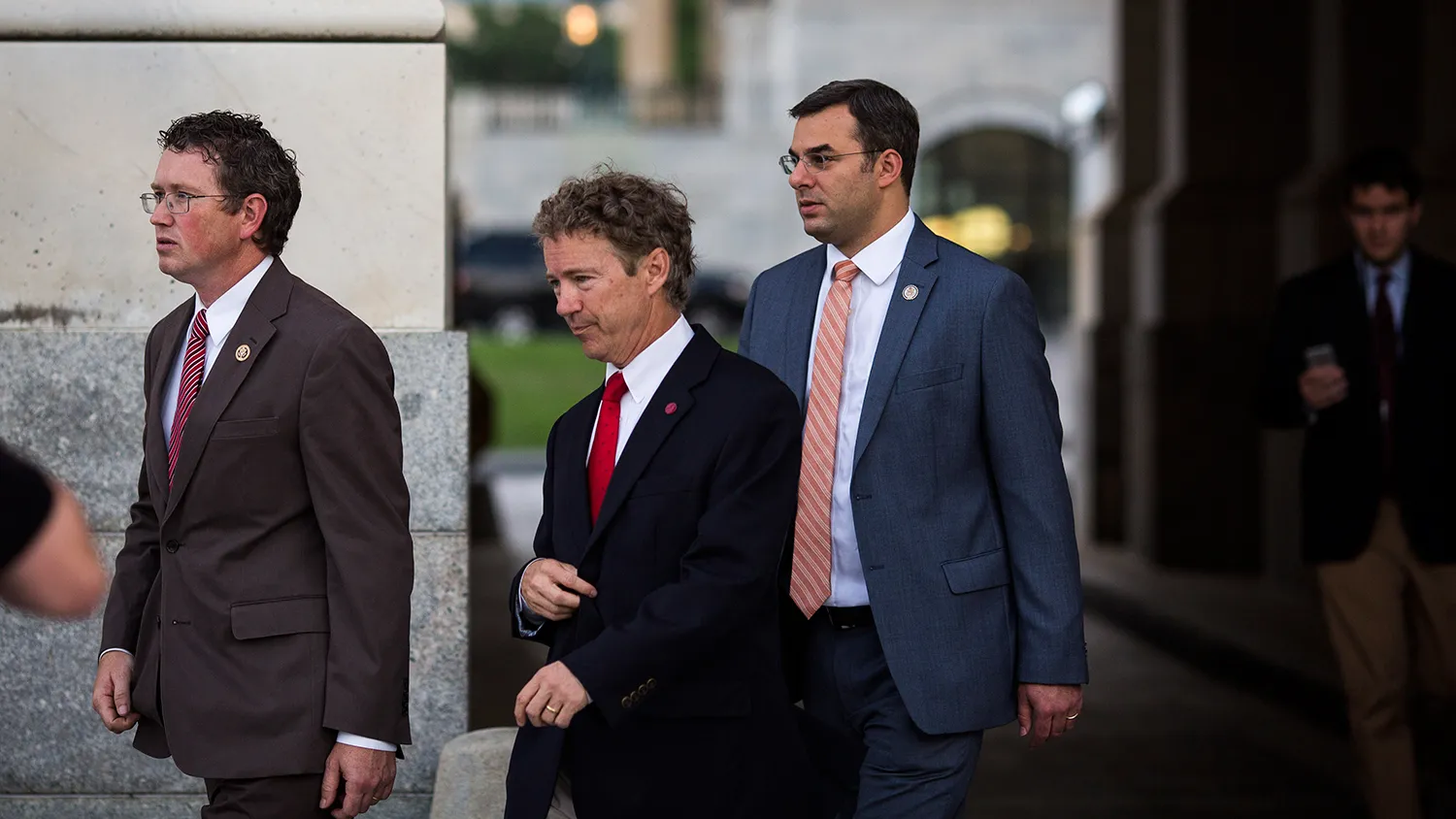 (L - R) Rep. Thomas Massie (R-KY), Sen. Rand Paul (R-KY) and Rep. Justin Amash (R-MI) exit the Senate chamber after Paul spoke about surveillance legislation on the Senate floor, on Capitol Hill, May 31, 2015 in Washington, DC.
