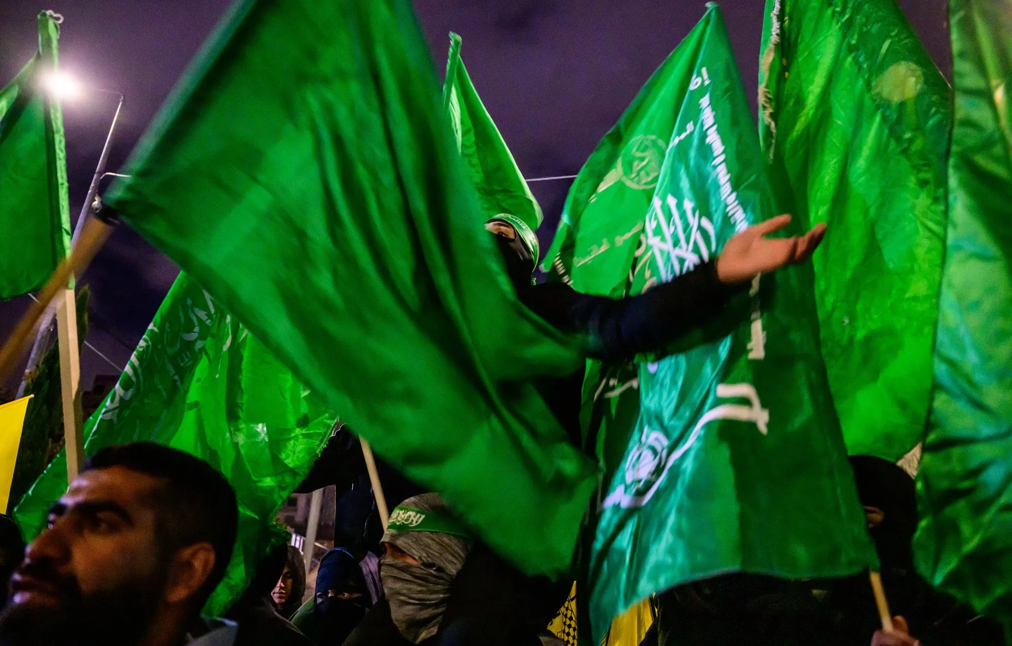 Palestinians wave Hamas flags as they wait for the release of Palestinian prisoners in Ramallah in the West Bank, on Nov. 27.