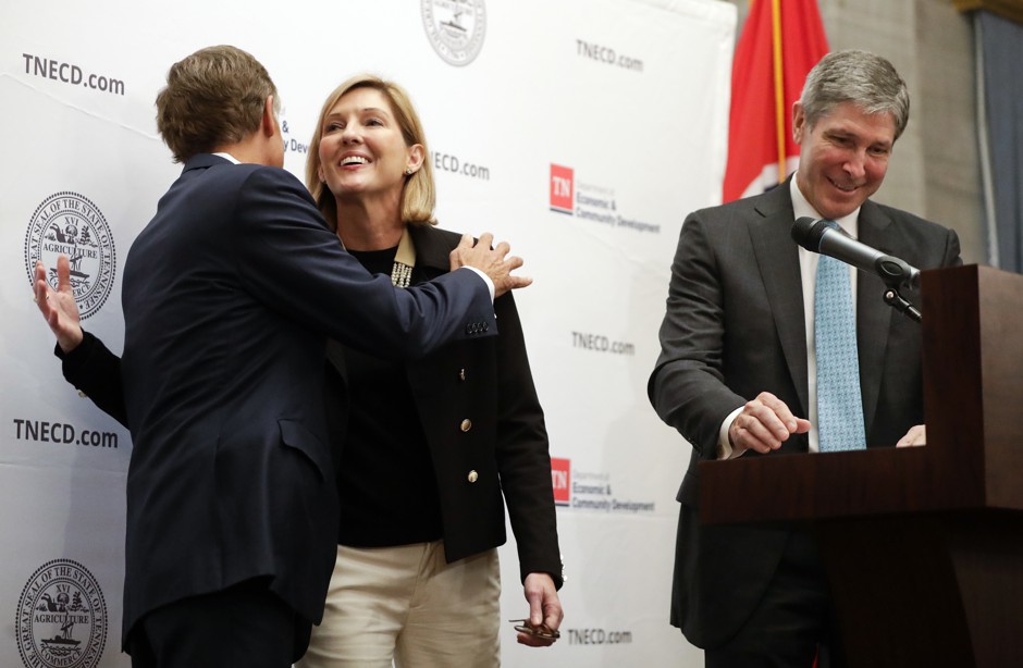 Holly Sullivan, of Amazon Public Policy, hugs Tennessee Governor Bill Haslam during an announcement that Amazon will locate an operations hub in Nashville, Tennessee.