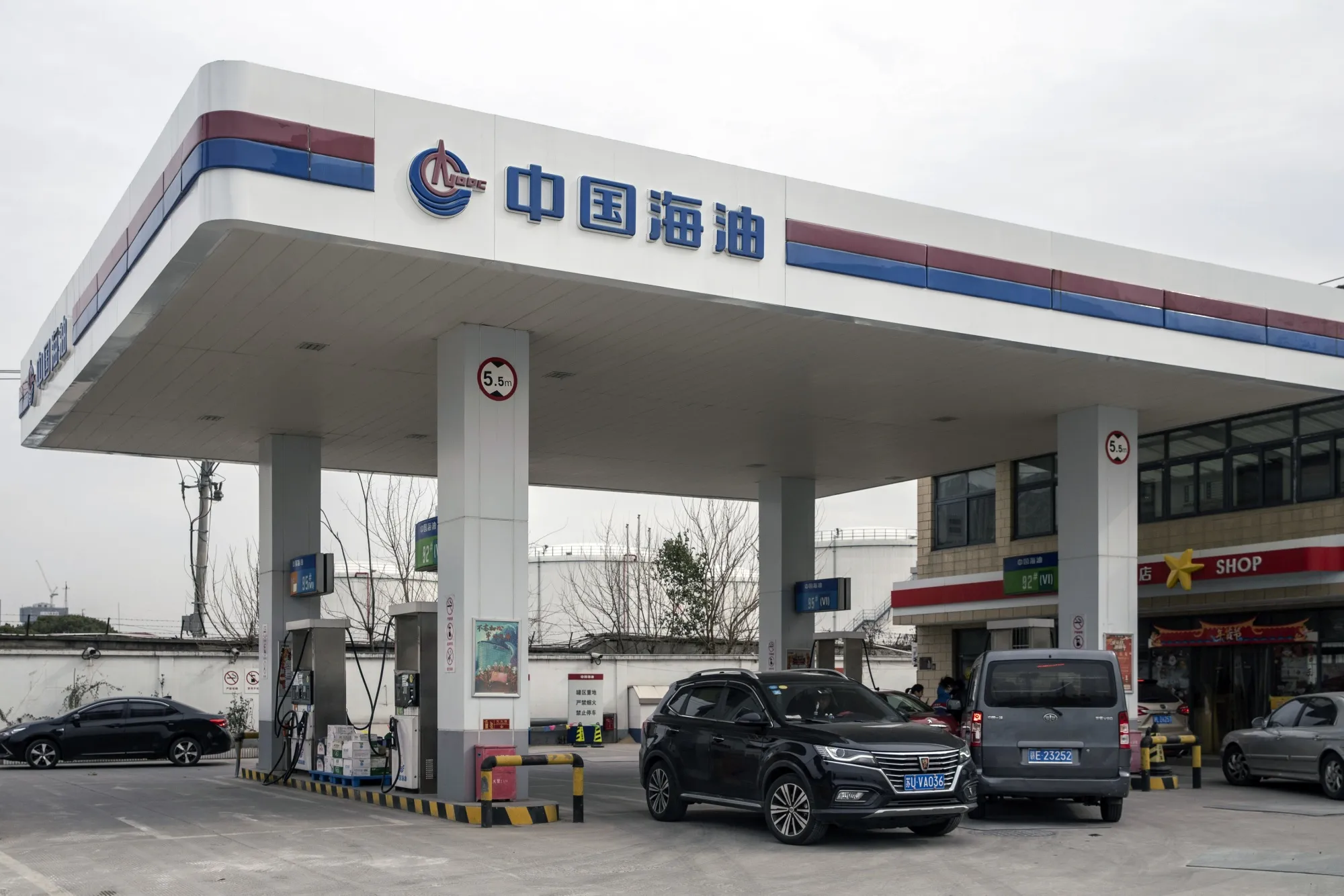 Vehicles refuel at a Cnooc Ltd. gas station in Shanghai.