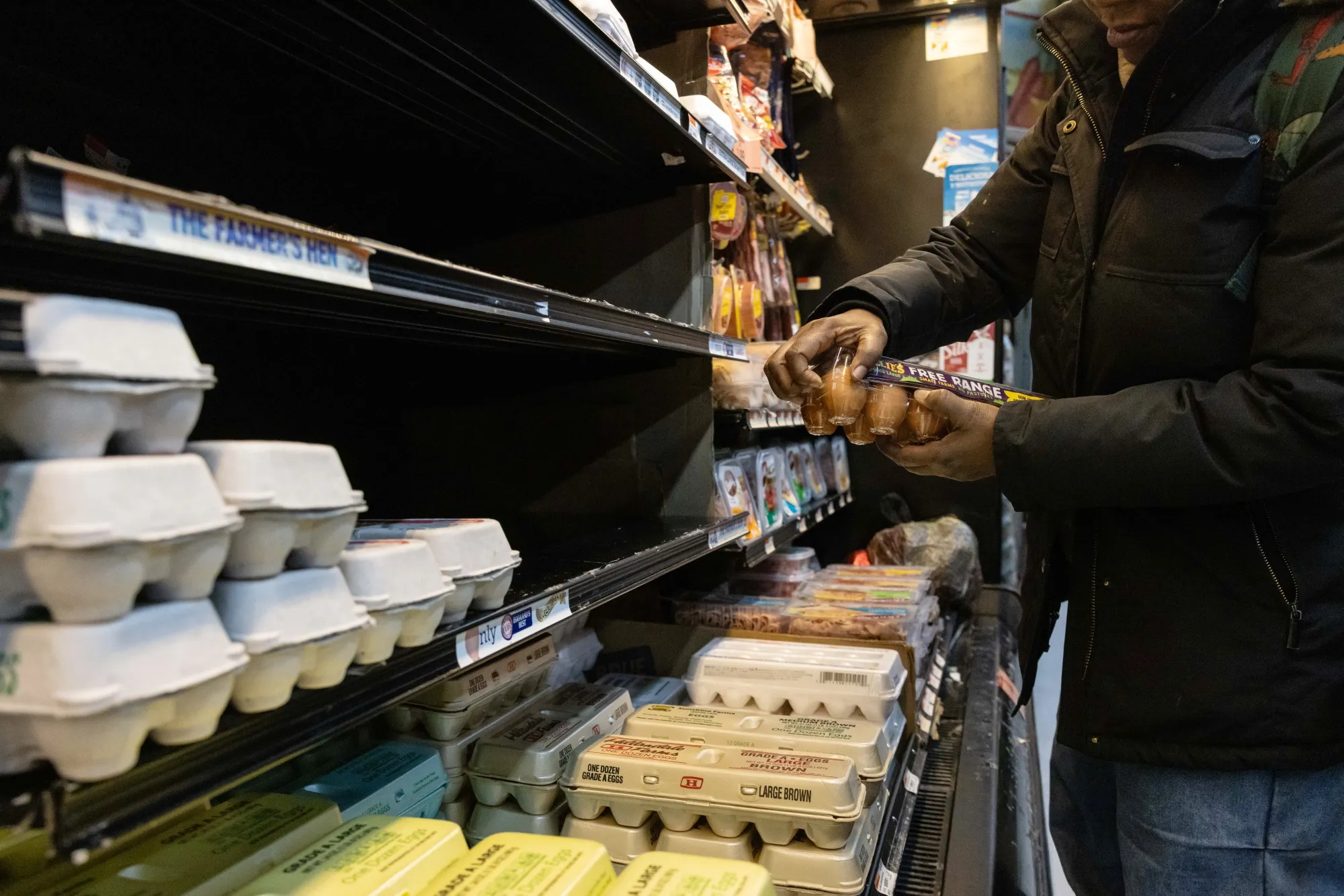 A shopper picks up eggs at a grocery store in New York, US.
