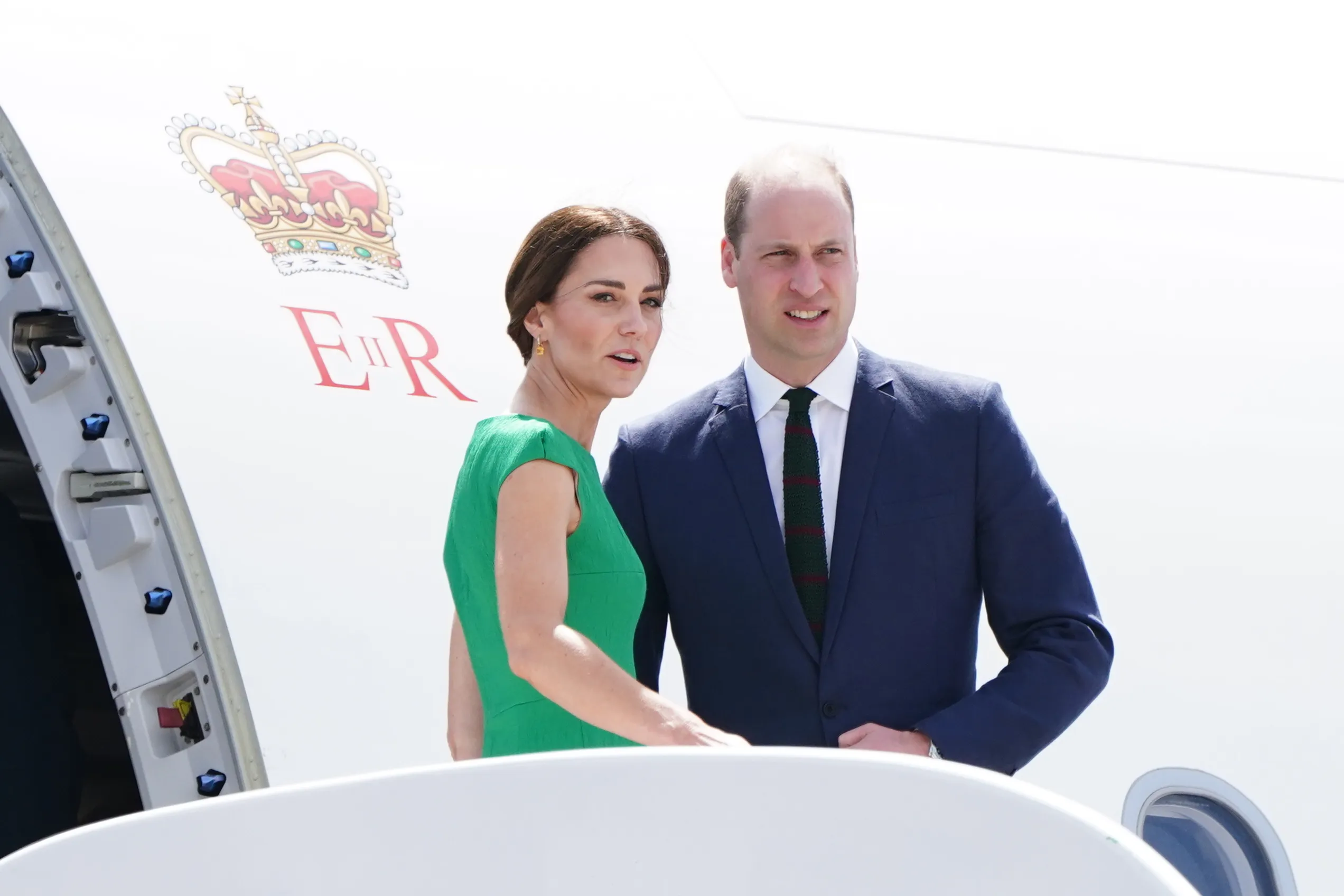 The Duke and Duchess of Cambridge stand on the steps of the plane as they depart Norman Manley International Airport&nbsp;in Jamaica&nbsp;to head to the Bahamas on March 24, 2022.
