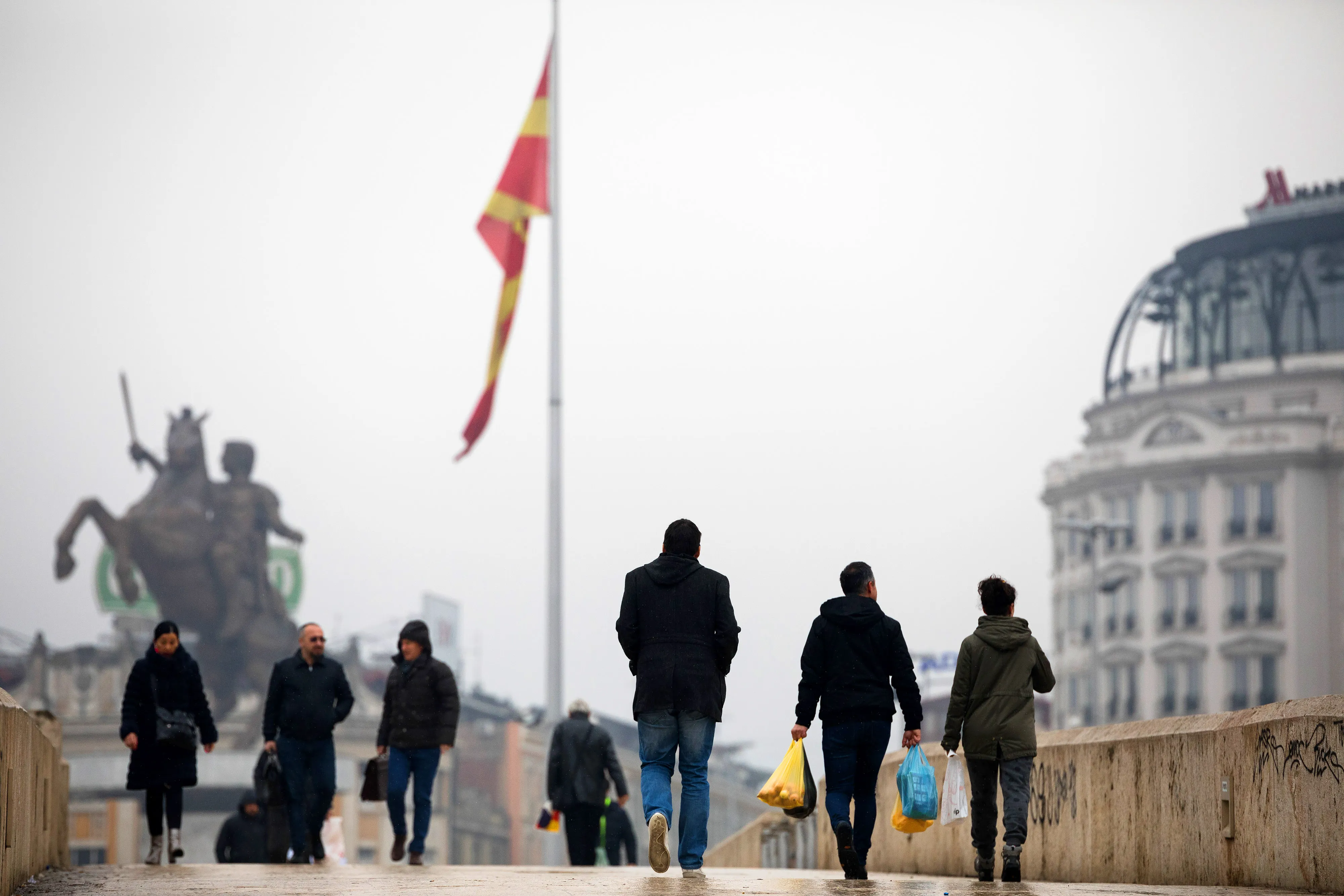Pedestrians cross a bridge in central Skopje.