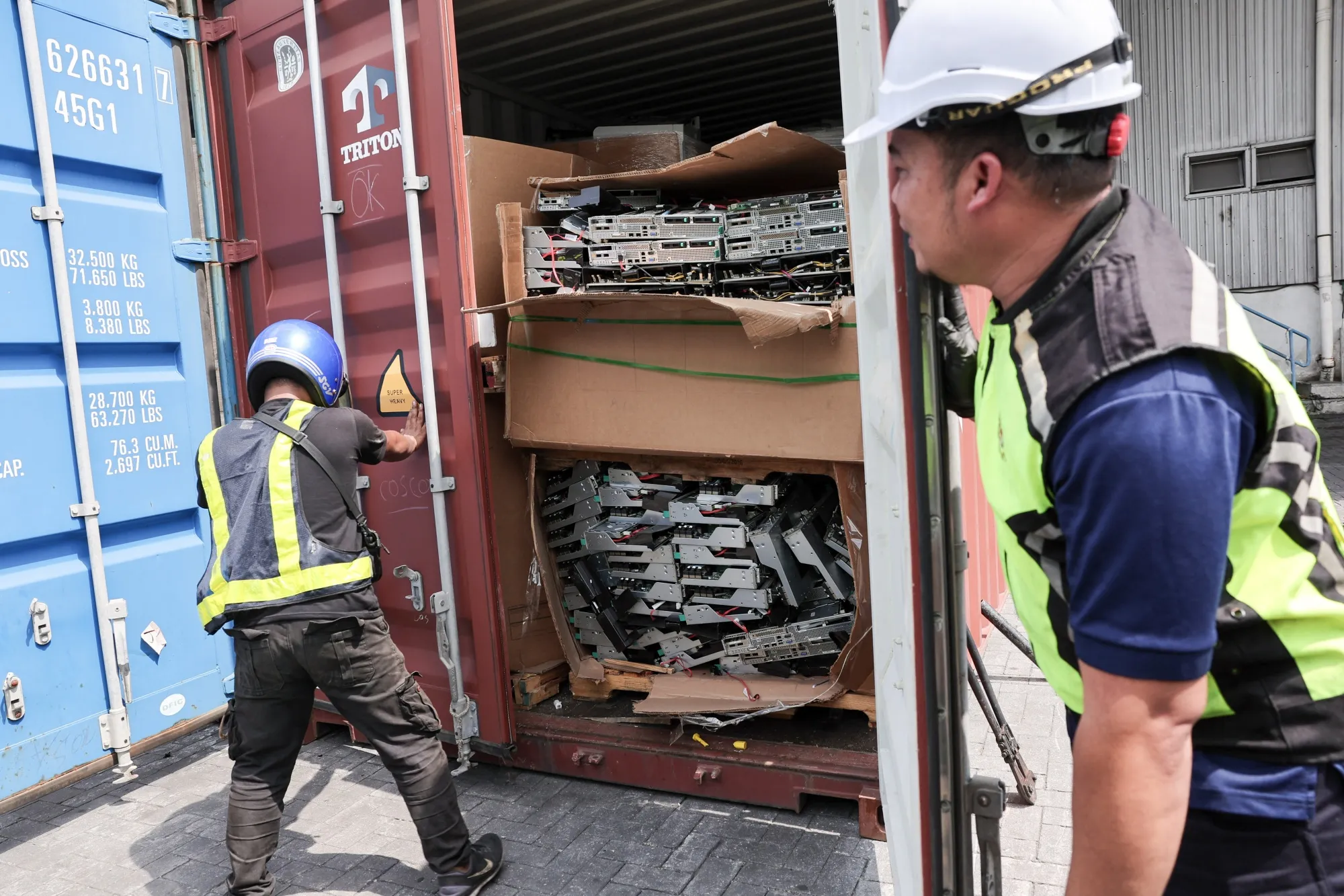 Malaysian officials open up a seized container with electronic waste in Port Klang on the outskirts of Kuala Lumpur in&nbsp;2024.&nbsp;