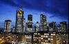 The Commerzbank AG headquarters, second left, and the Deutsche Bank AG twin towers, right, stand illuminated with other skyscrapers in the financial district in Frankfurt, Germany, on Monday, Jan. 13, 2020. Germany’s economy probably grew at the weakest pace since 2013 last year as carmakers to machinery makers were hit by trade tensions and the U.K.’s impending exit from the European Union, a report is expected to show Wednesday.