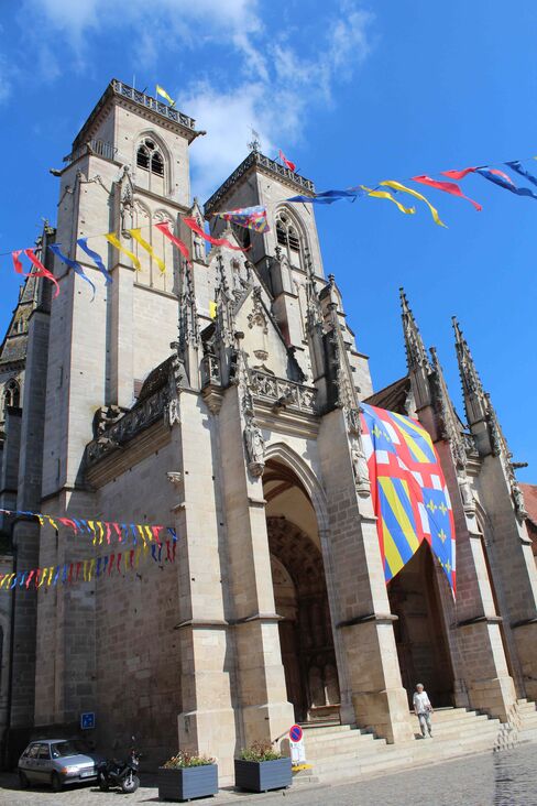 The cathedral at the heart of Semur-en-Auxois is festooned with banners heralding an early summer festival.