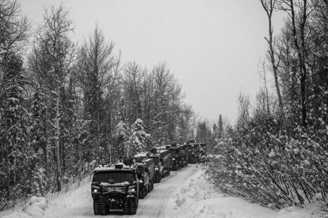 Several BAE Systems Plc Cold-Weather All-Terrain Vehicles (CATVs) travel on a snow-covered road during a Joint Pacific Multinational Readiness Center exercise in Alaska,