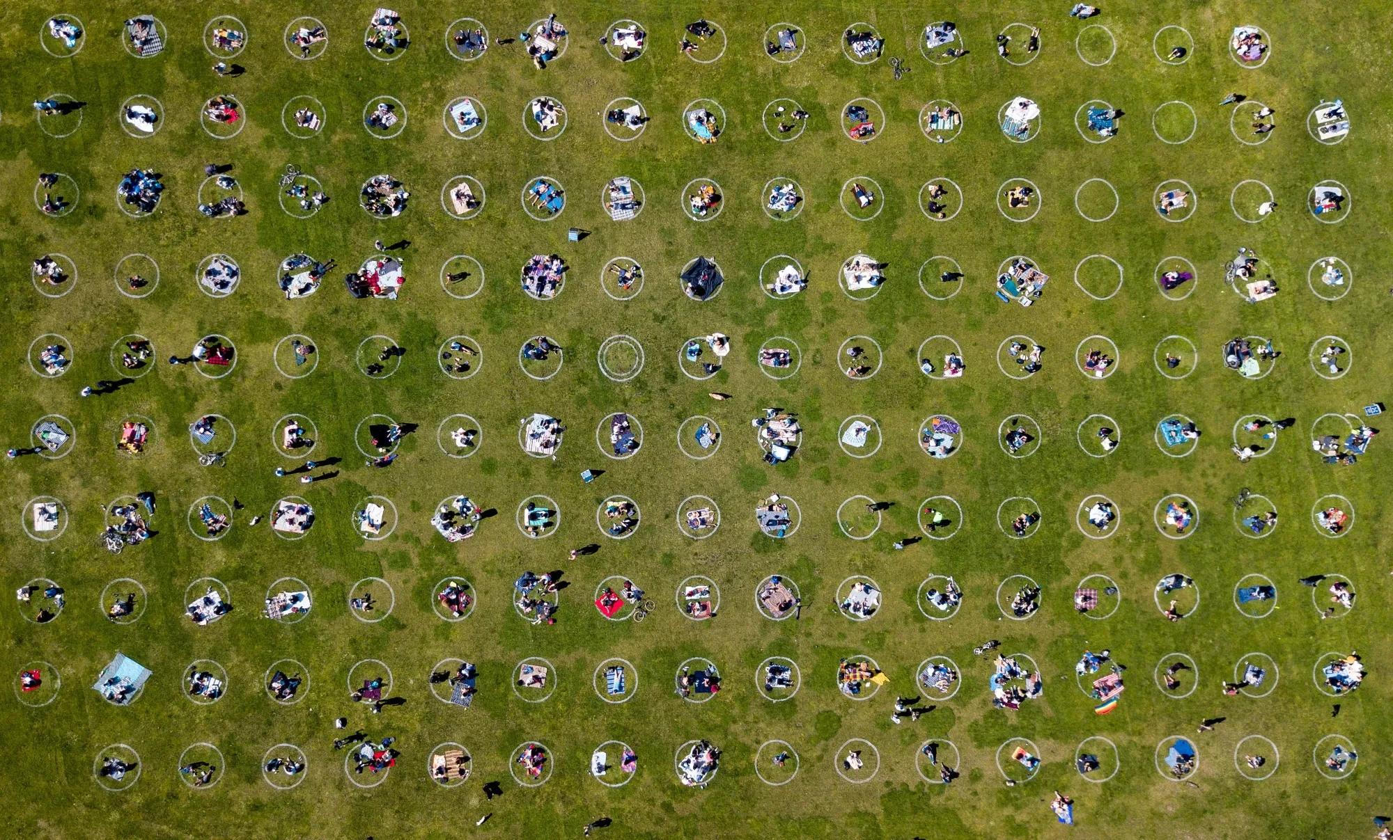 TOPSHOT - An aerial view shows people gathered inside painted circles on the grass encouraging social distancing at Dolores Park in San Francisco.&nbsp;