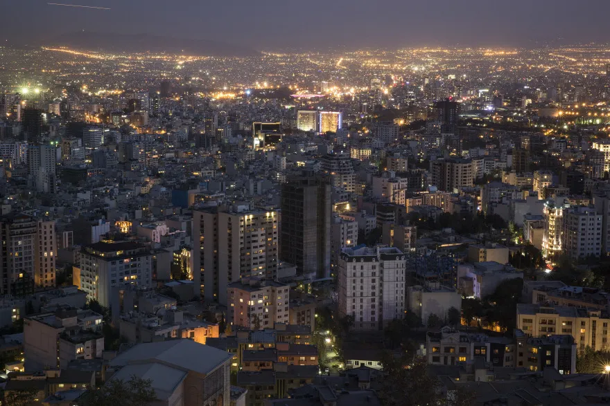 Residential and commercial properties sit illuminated on the city skyline in Tehran, Iran.