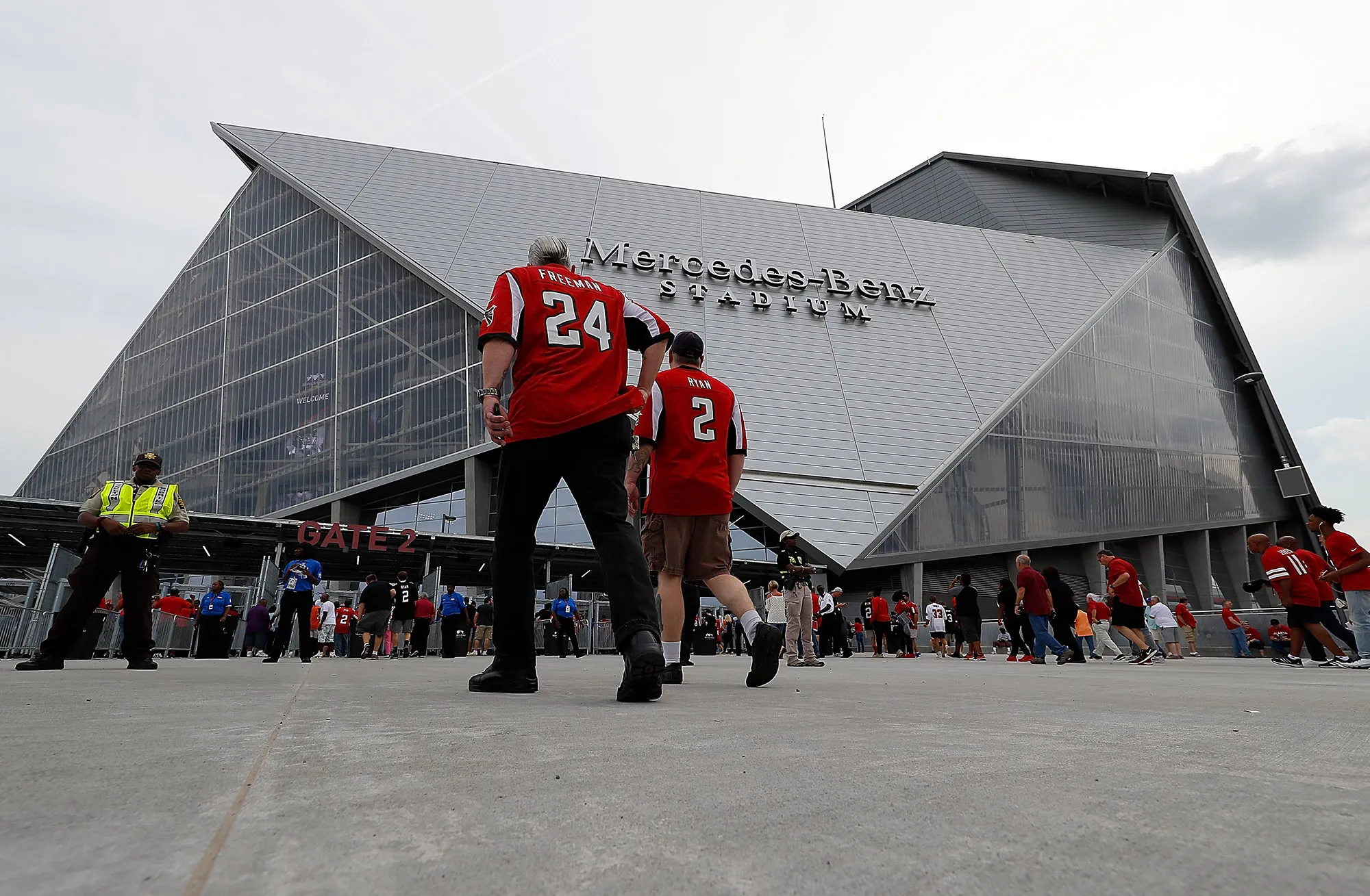Fans enter the gates at Mercedes-Benz Stadium.