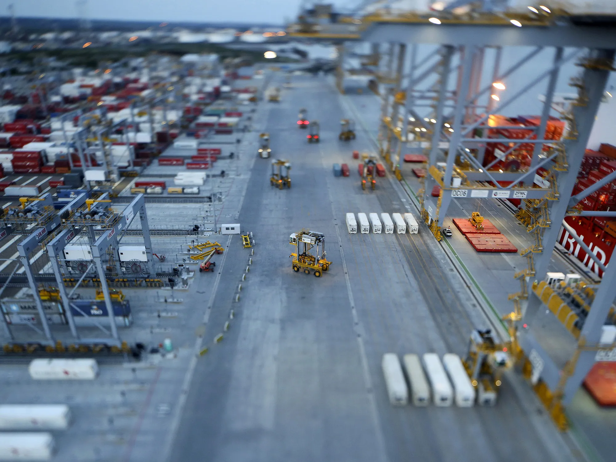 Straddle carriers move freight containers at a deep-sea port, in Stanford-le-Hope, U.K.