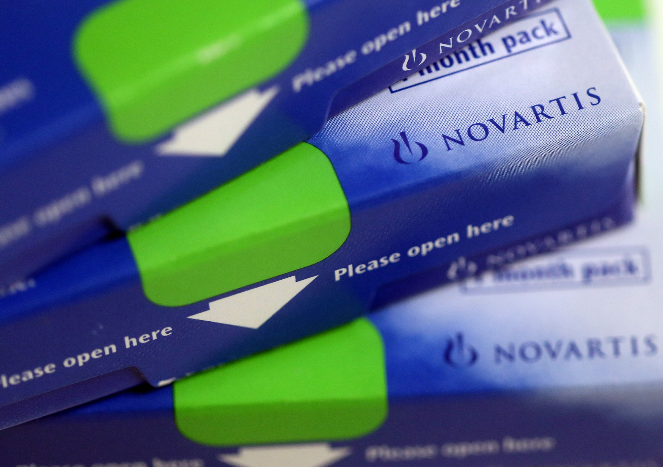 Boxes of tablets, produced by Novartis AG, sit on a pharmacy counter in this arranged photograph in London, U.K., on Thursday, Dec. 29, 2016.
