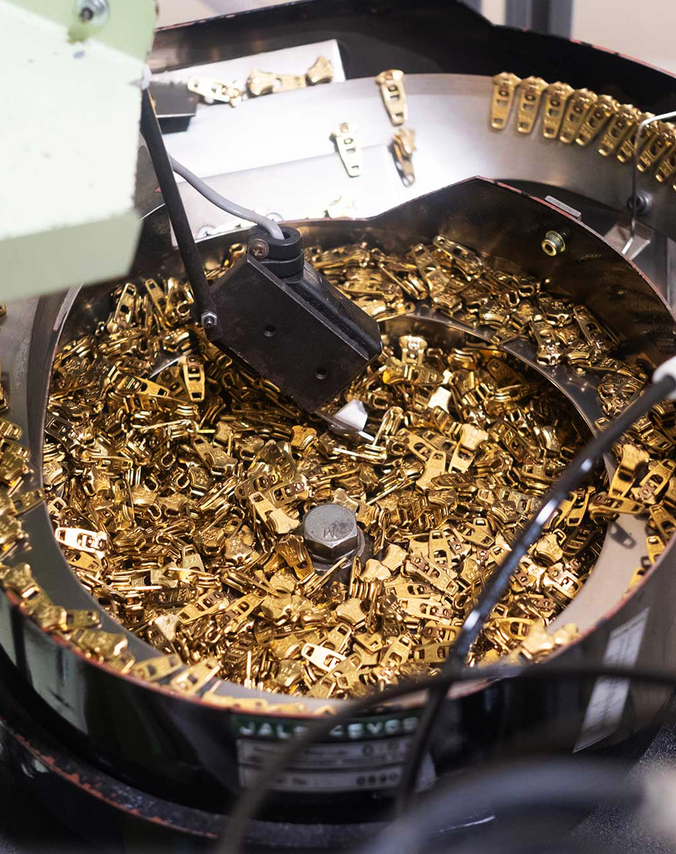 Metal “Slider parts feeder” start to feed into a production line at YKK’s facility in Macon.