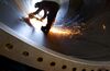 A worker cuts metal at a manufacturing plant in Stevensville, Ontario, Canada.