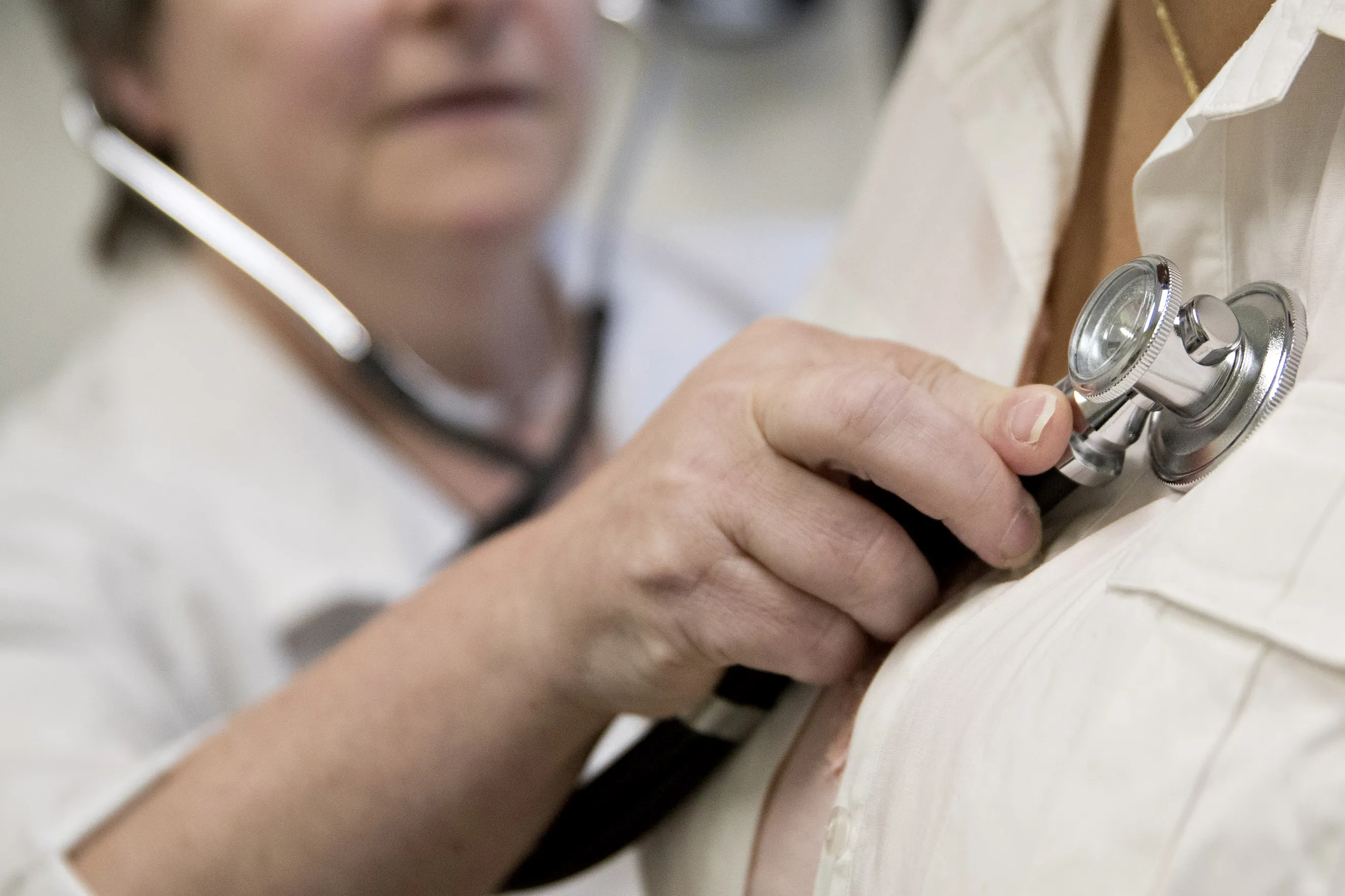 A family practice physician examines a patient with a stethoscope at a CCI Health and Wellness Services health center in Gaithersburg, Maryland, U.S., on Tuesday, April 18, 2017. After the failure of Republicans first attempt to repeal and replace the Affordable Care Act and President Donald Trumps subsequent threats to let the program explode, more health insurers are threatening to pull out of the Obamacare health-care program next year, while others may sharply raise the premiums they charge.
