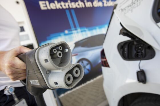 Merkel Cheers VW’s Electric Push Amid Growing Climate Critique