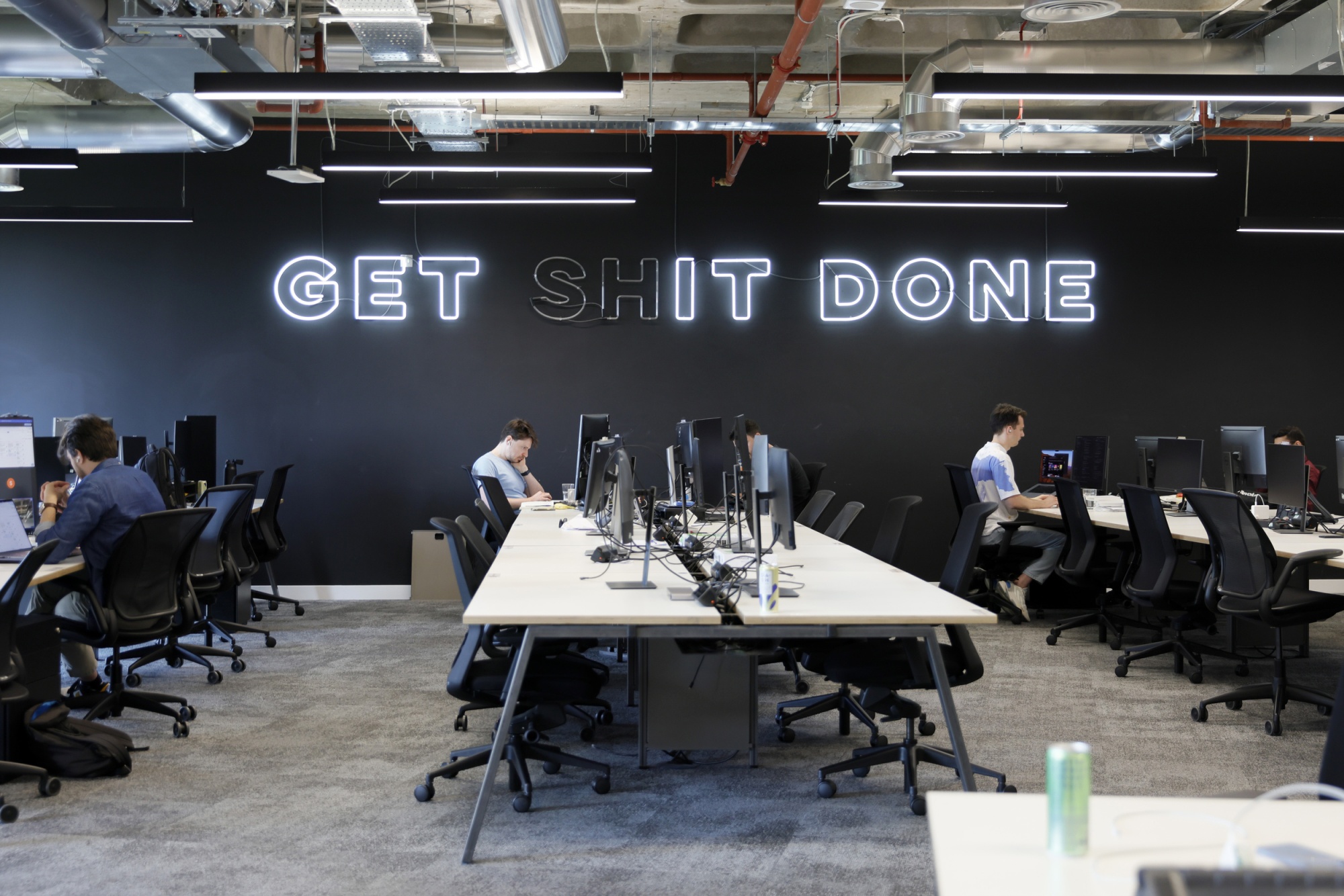 An illuminated slogan, “Get It Done," hangs in Revolut's UK office in June 2024. Photographer: Vivian Wan/Bloomberg