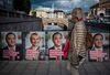 A woman walks next to election posters in Stockholm Sept. 1.