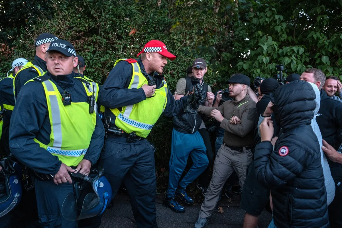 Police officers scuffle with protesters outside a hotel in Epping, England on July 20.&nbsp;