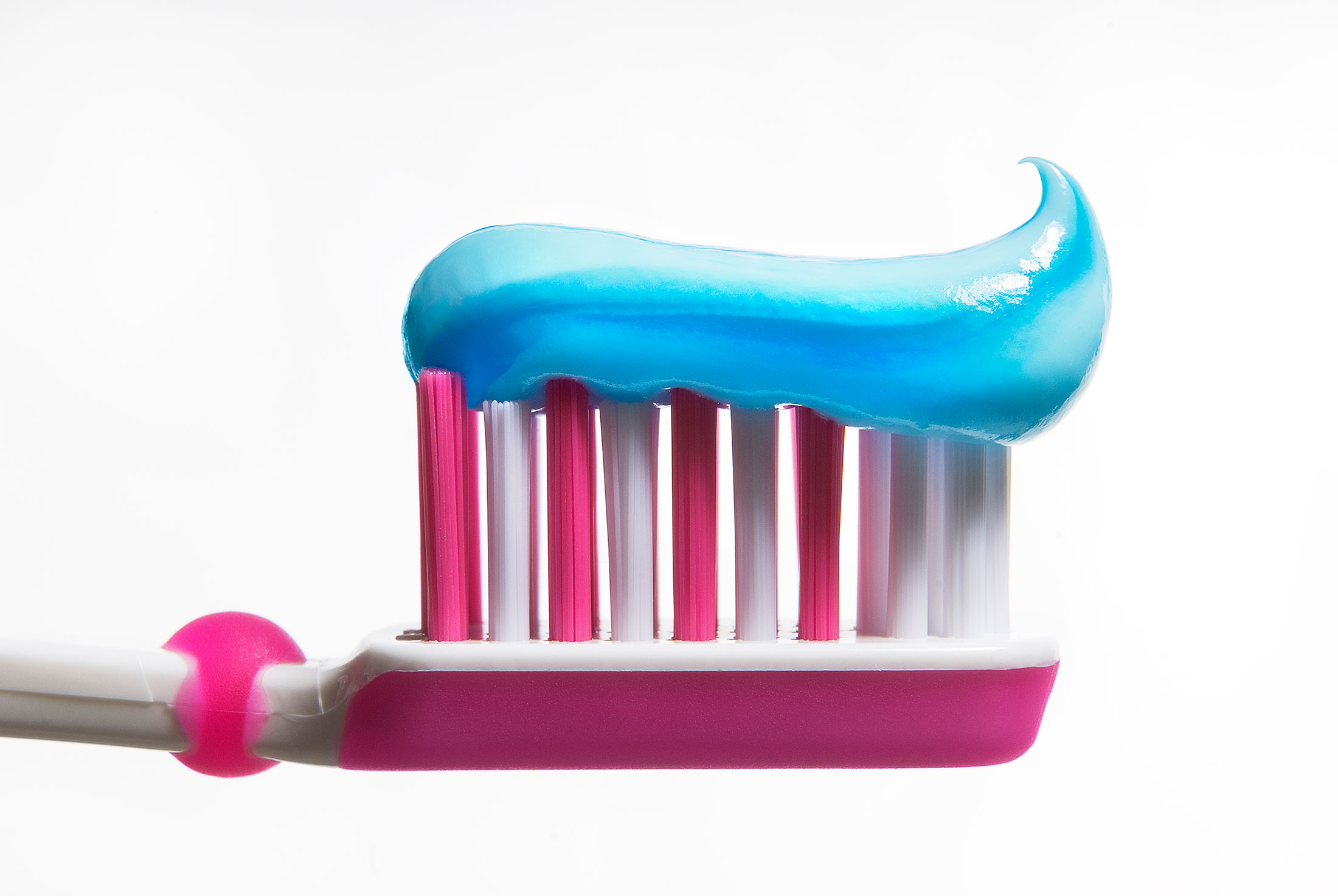 pink toothbrush with blue toothpaste