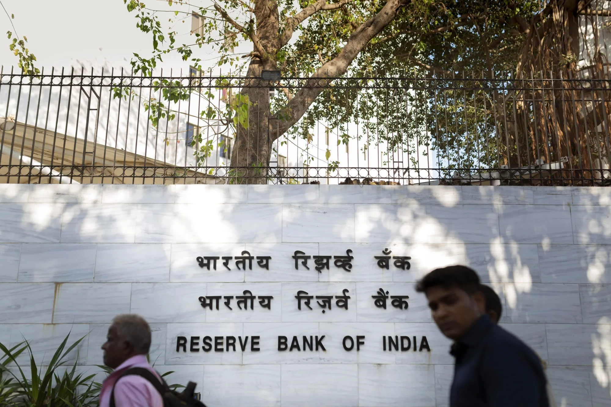 Pedestrians walk past the Reserve Bank of India (RBI) in Mumbai, India, on Tuesday, March 3, 2020. RBI Governor Shaktikanta Das said he's ready to act to shield the economy from the coronavirus and reiterated there's room to cut interest rates if needed.