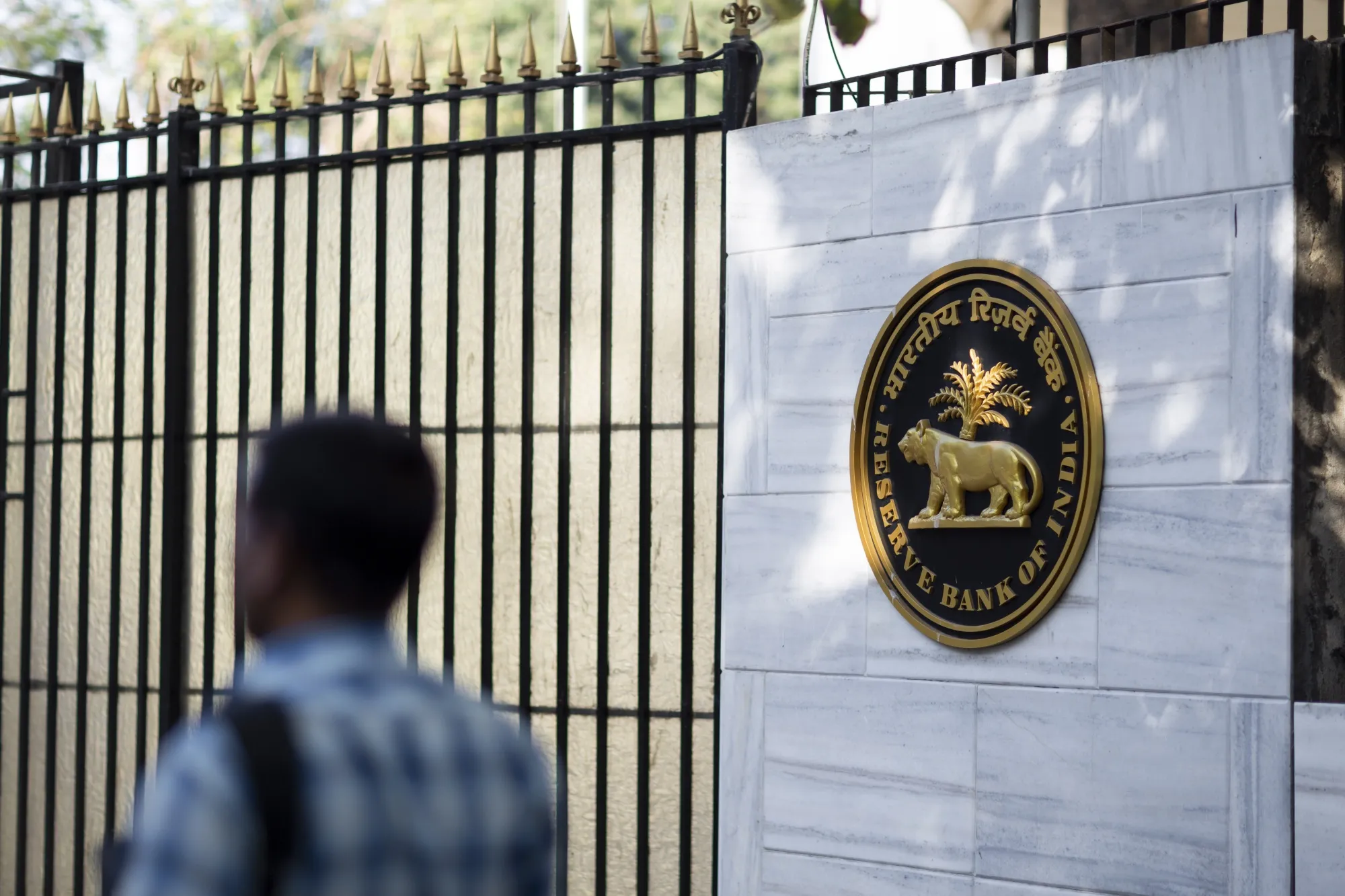 A pedestrian walks past the Reserve Bank of India building in Mumbai.