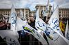 Attendees wave flags and gather during an election campaign rally for The League party at Duomo Square in Milan, Italy.