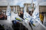 Attendees wave flags and gather during an election campaign rally for The League party at Duomo Square in Milan, Italy.
