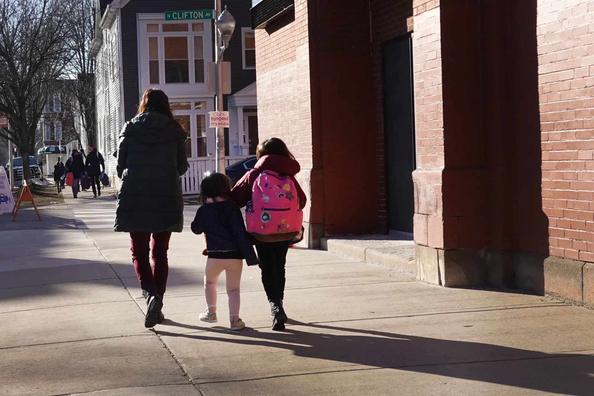 A parent picks up their children from school in Chicago.