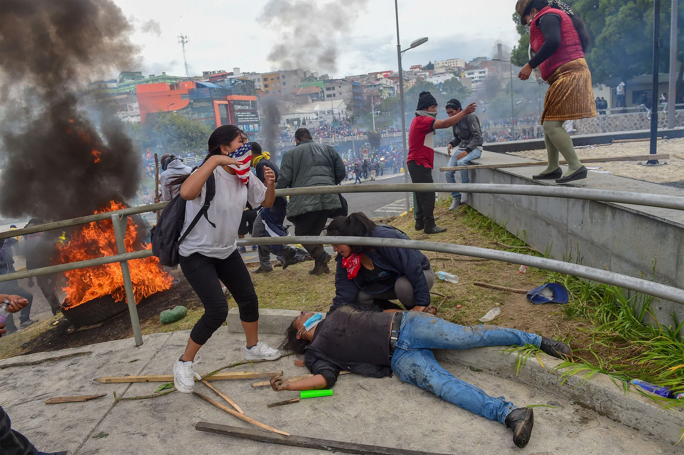 A protester lies on the ground as demonstrators are dispersed away from the national assembly by riot police, in Quito on Oct. 8.&nbsp;f