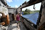 A woman clears her damaged home in the Kharkiv region. Local authorities reported missile strikes in the region.