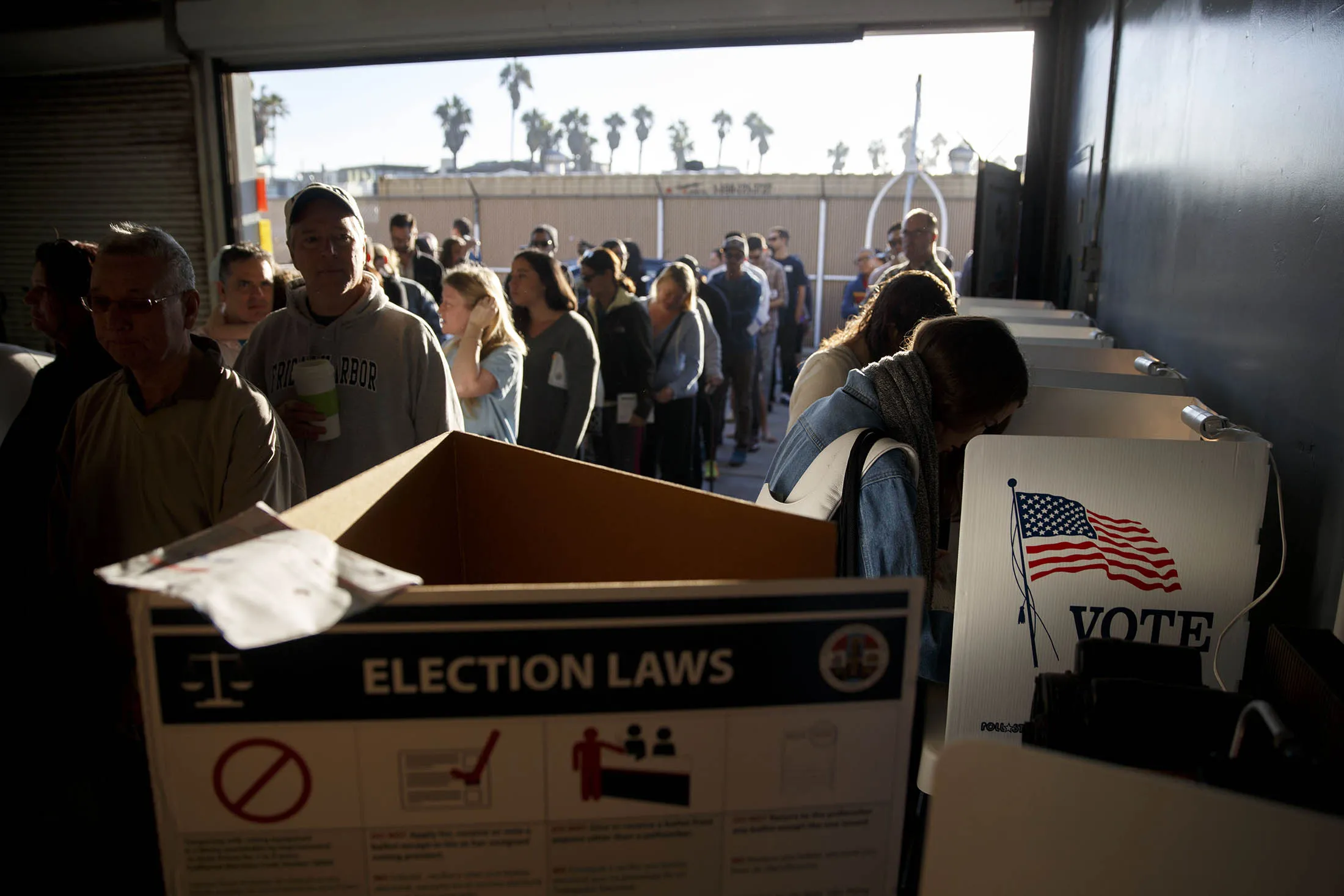 Voters wait in line to cast their ballots at the Venice Beach lifeguard station polling location in Los Angeles, California, U.S., on Tuesday, Nov. 8, 2016. Americans streamed to the polls under clear skies in much of the country Tuesday to bring the presidential election between Hillary Clinton and Donald Trump to a close -- and to signal whether they want to preserve the U.S. political establishment or blow it up.
