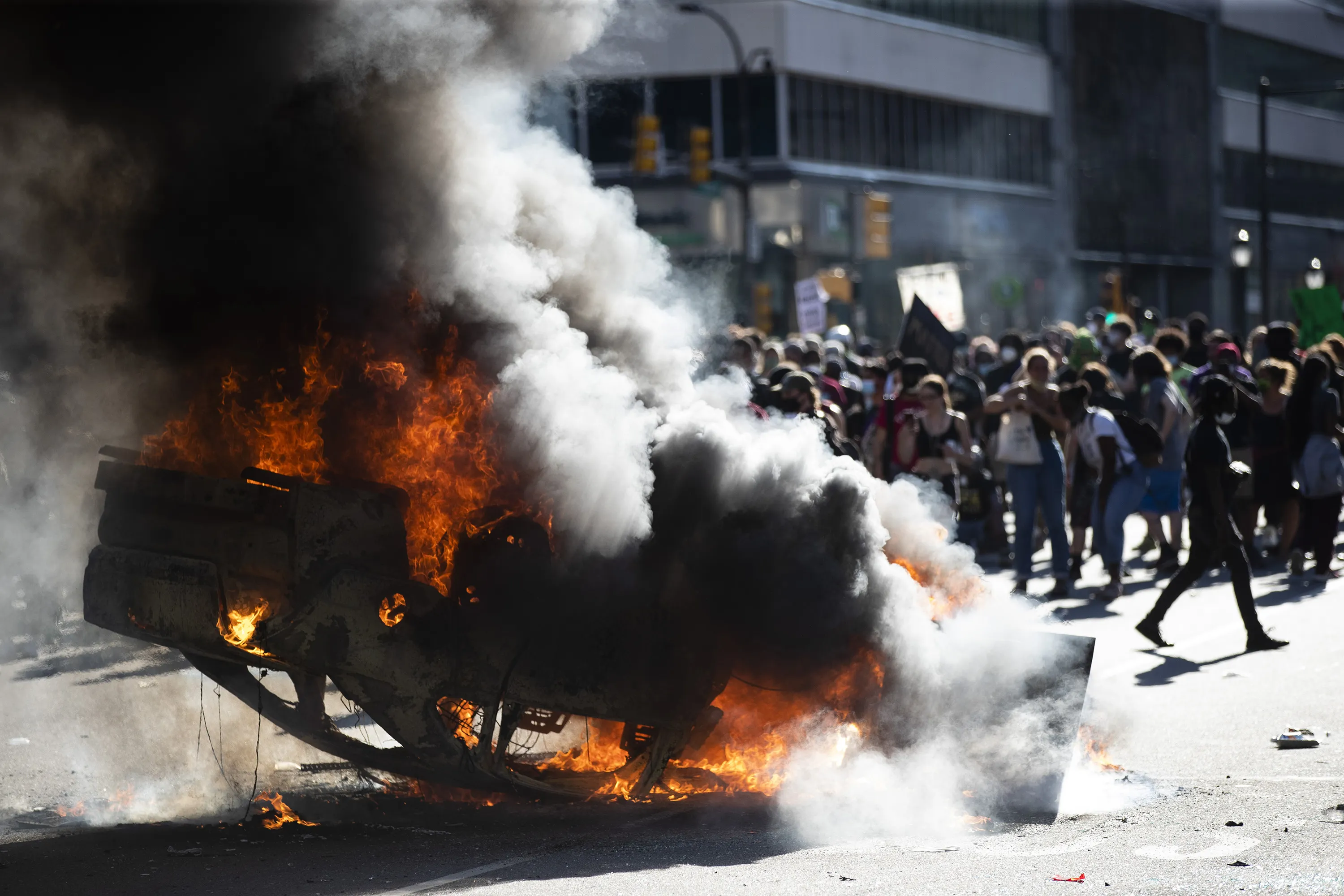Smoke rises from a fire on a police cruiser during a protest in Philadelphia on May 30.