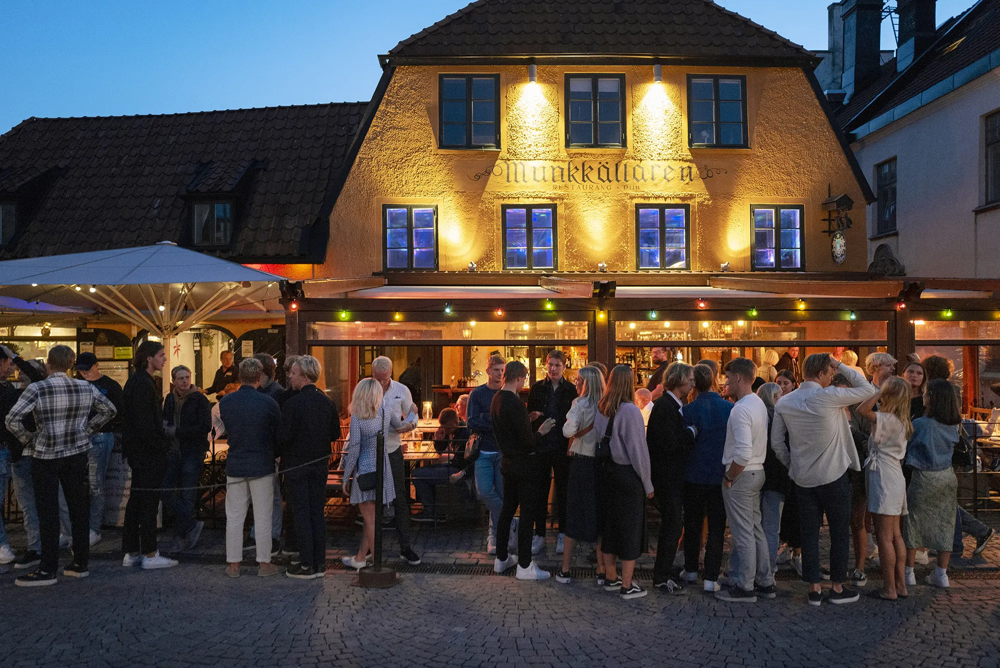 People stand in line without social distancing outside a restaurant in Gotland, Sweden, in July, 2020.&nbsp;
