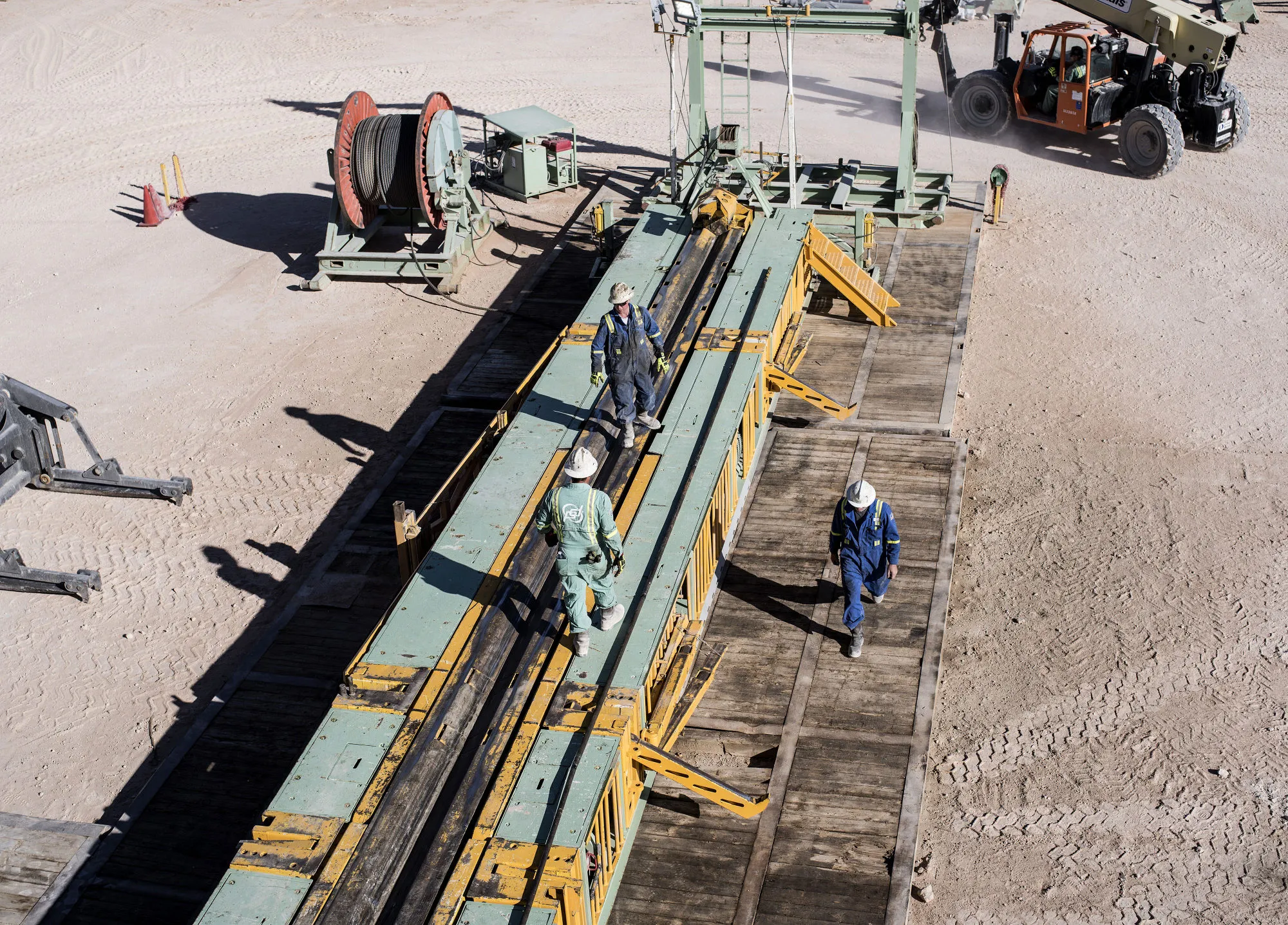 Precision Drilling oil rig operators work on a oil rig near Mentone, Texas.