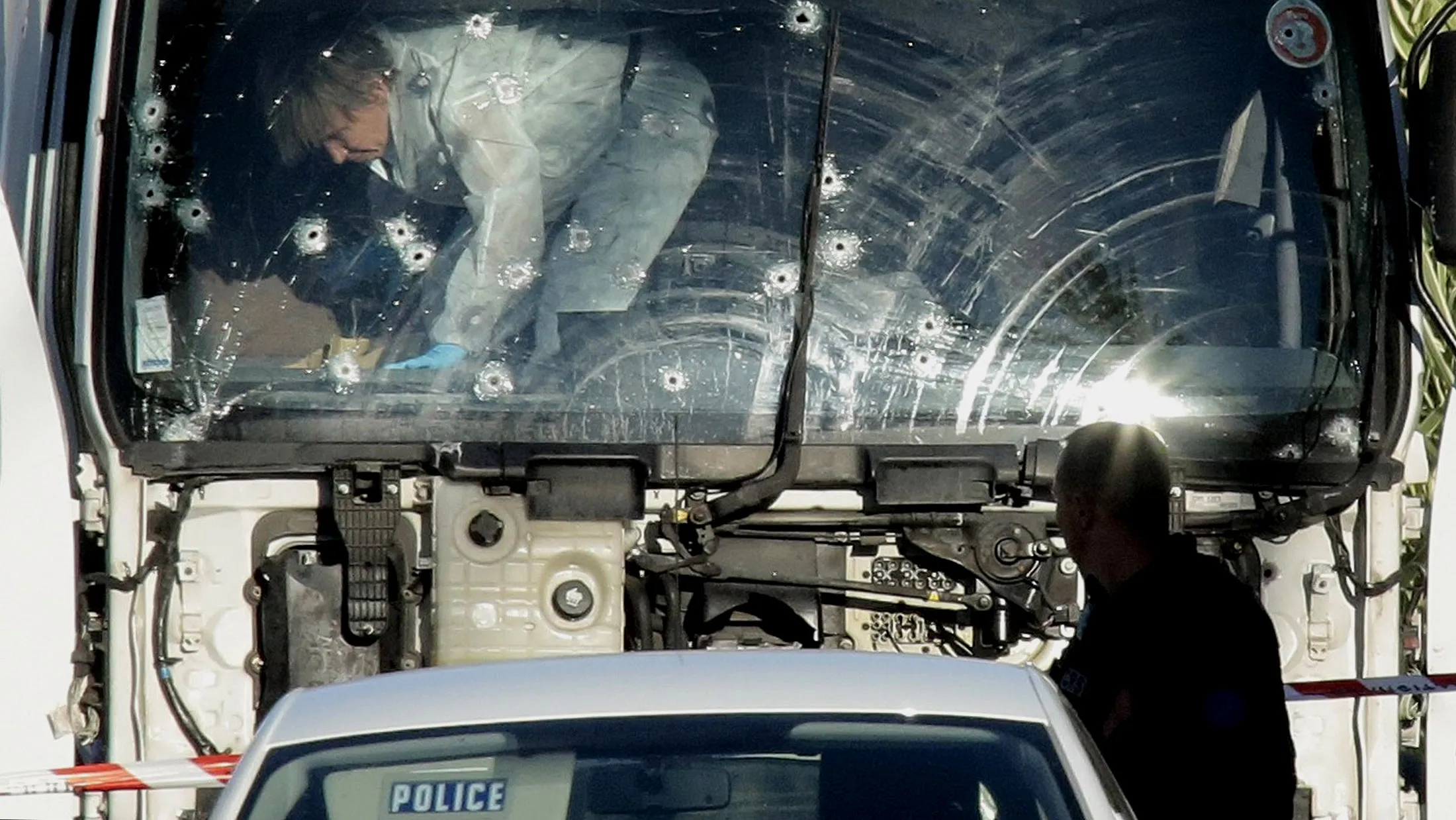 Forensic police investigate a truck at the scene of a terror attack.
