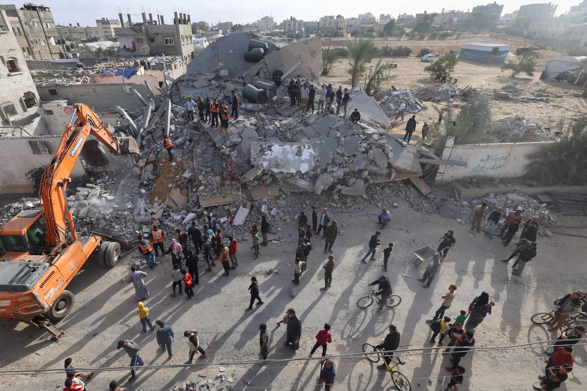 Rescue workers search for survivors under the rubble in Rafah, on April 21.