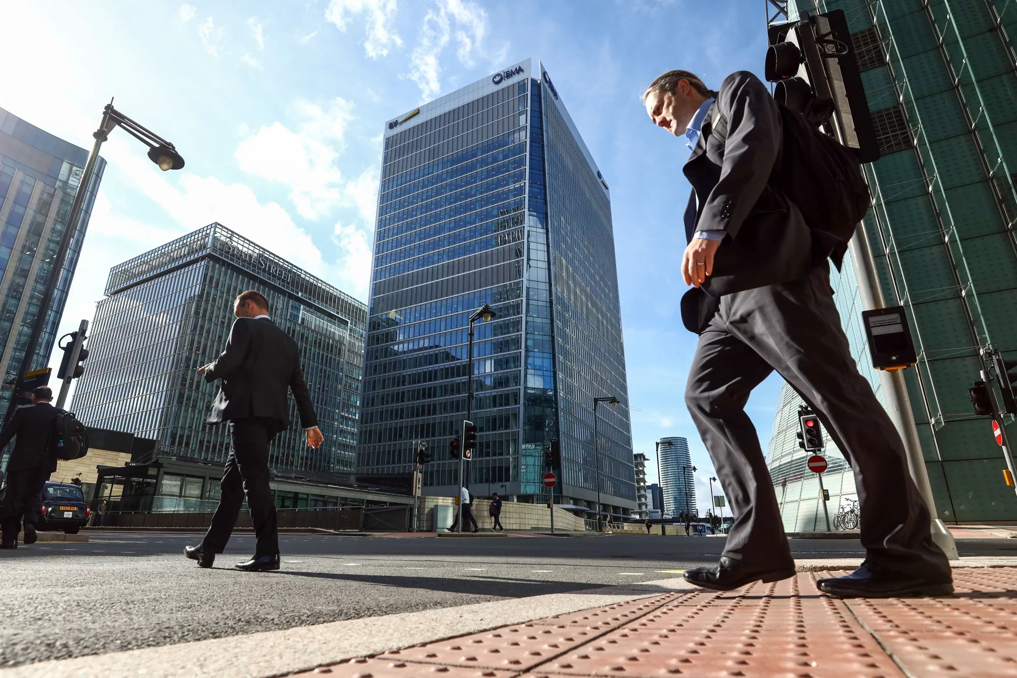 Pedestrians pass 30 Churchill Place which houses the European Medicines Agency, in Canary Wharf London.
