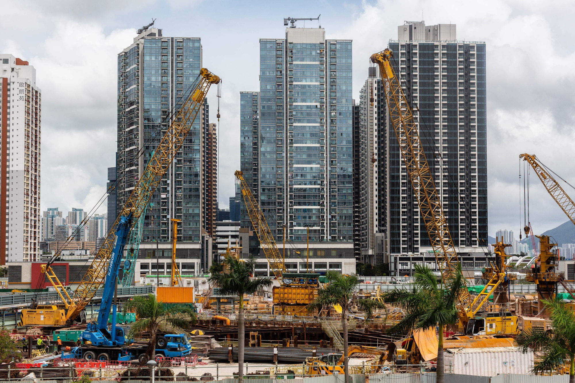 Cranes stand at a construction site at the former Kai Tak airport area.