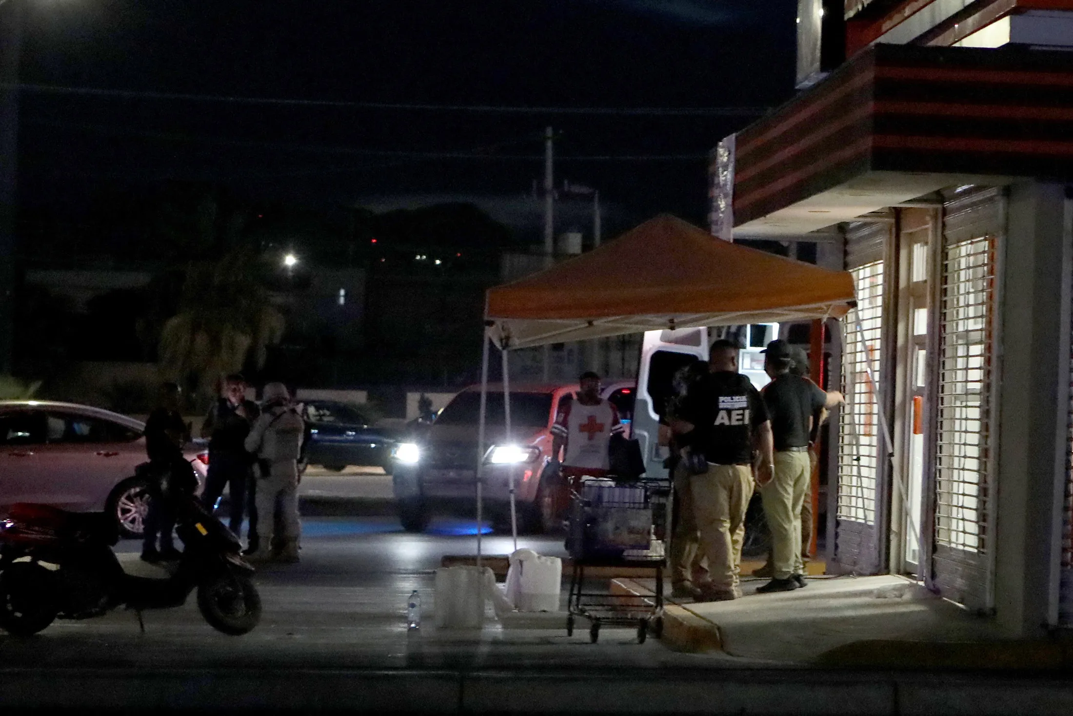 Members of the National Guard and forensic experts work at the site where four radio station workers were killed and two restaurant employees wounded in Ciudad Juarez, Mexico, on Aug.&nbsp;11.