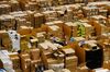 A worker picks an item for a customer's order at an Amazon.com Inc. fulfillment center in Peterborough, U.K.