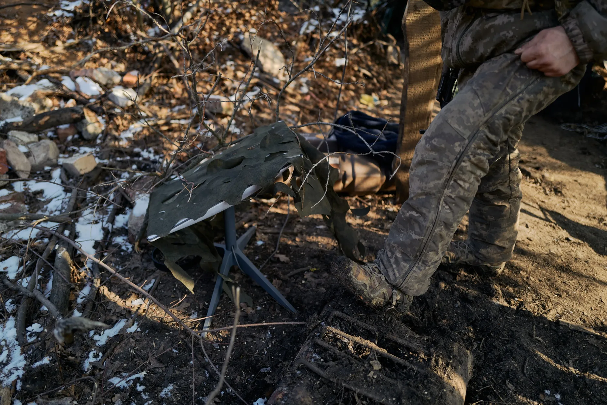 A Ukrainian soldier near a Starlink device in Pokrovsk, Ukraine.