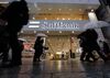 Pedestrians walk past a SoftBank Group Corp. store in Tokyo, Japan.