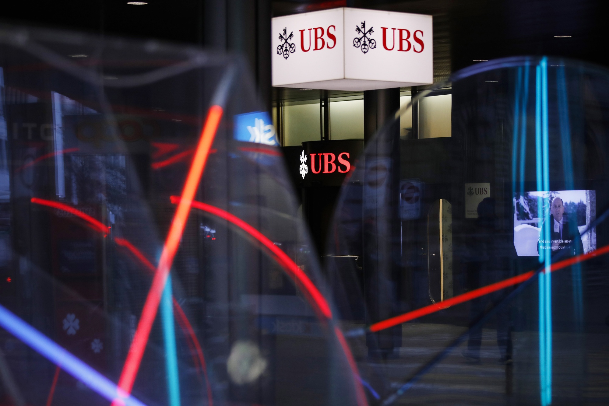 Illuminated UBS Group AG logos outside the company's headquarters in Zurich, Switzerland, on Tuesday, Jan. 26, 2020. UBS plans to buy back as much as 4 billion francs ($4.5 billion) of shares over the next three years, bolstering shareholder returns after income from managing client assets and investment banking propelled gains at the world’s largest wealth manager.