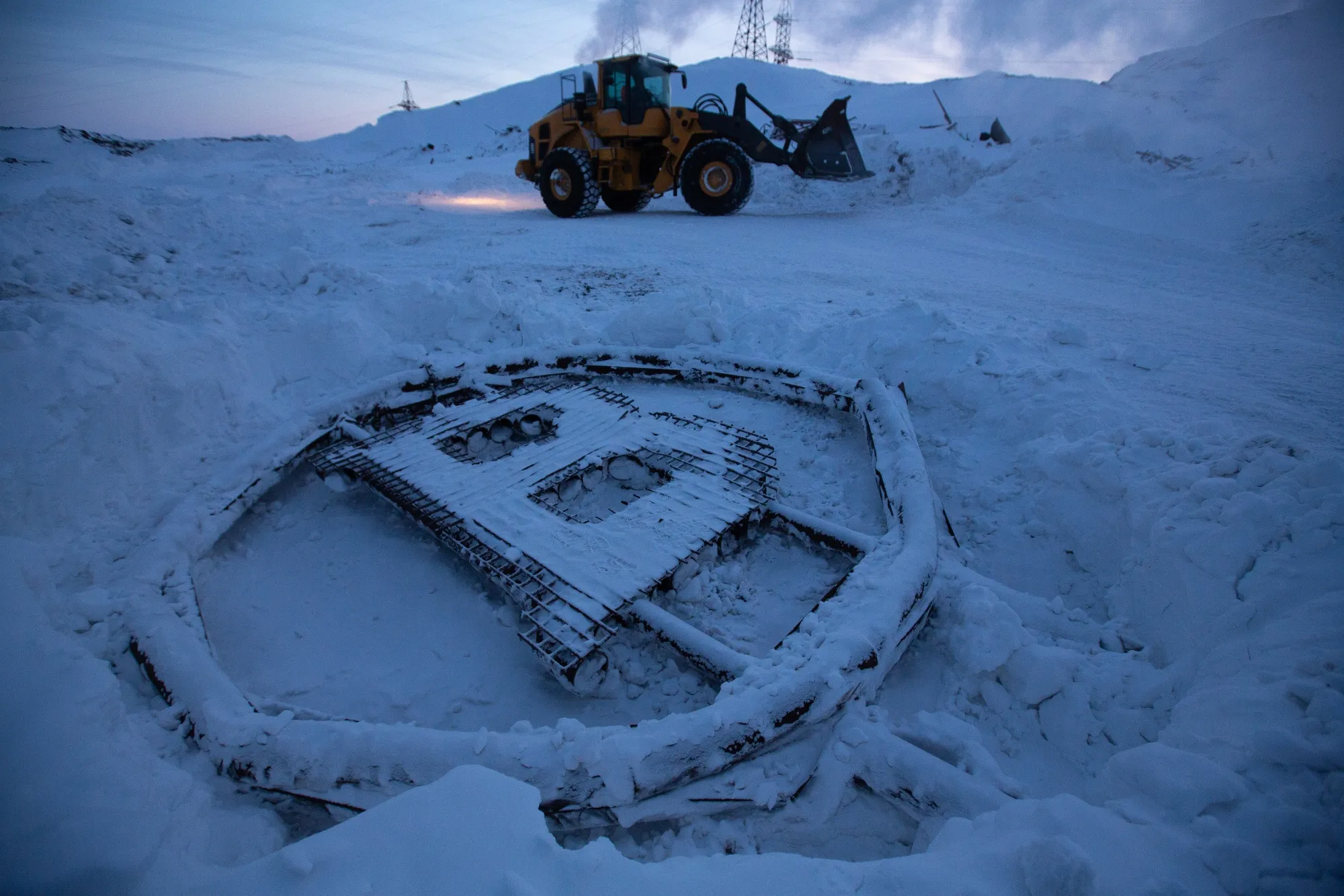 A bitcoin sculpture on the ground outside a cryptocurrency mining farm in Norilsk, Russia.